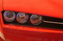 Headlight  Closeup Of A Red Car