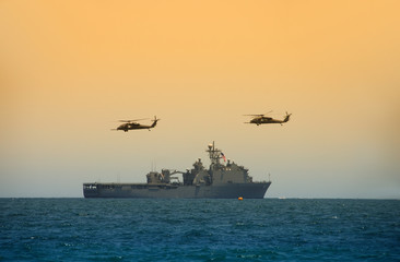 Wall Mural - Navy battleship with hovering helicopters