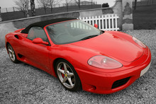 Bright Red Convertible Sports Car On A Black And White Backgroun