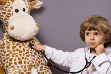 beautiful four years old playing with stethoscope