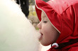 young girl eating candyfloss