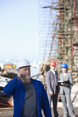 Wall Mural - Oil rig survey engineer talking on cellphone