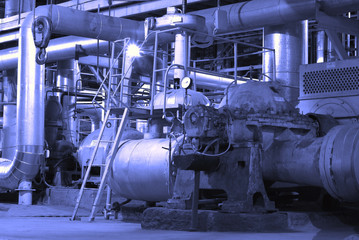 Equipment, cables and piping as found inside of a modern industr