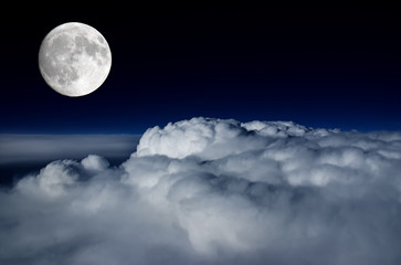 full moon above cloud deck
