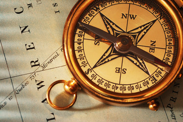 antique brass compass over old canadian map