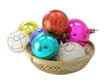 varicoloured fir-trees toys in a small basket isolated 