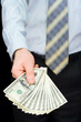 © Podfoto - The man in a suit, offering a pack of dollars
