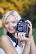 © 5AM Images - young blonde woman holding camera