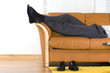 © Alexey Stiop - Business man is relaxing on the couch after a long week