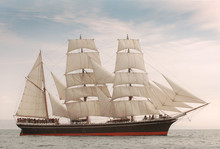 Vintage Windjammer Style Ship With Full Sails On The Open Sea