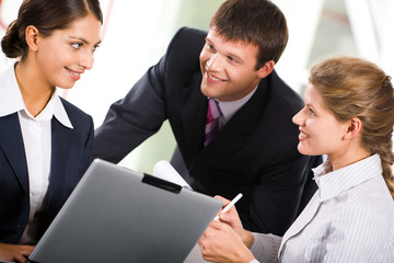 Canvas Print - Three  white collar worker interacting at business meeting