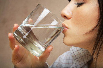 young woman with glass of mineral water