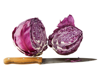 A red cabbage cut in half and a knife, isolated on white.