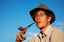 Man In Hat Is Smoking Tobacco-pipe