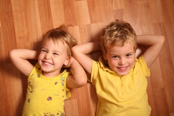 Wall Mural - two children lie on the floor 3