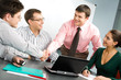 © pressmaster - Portrait of confident people shaking hands at business meeting