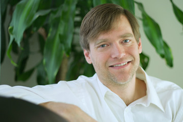 Handsome businessman in casual attire relaxing.