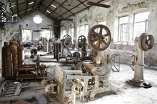 Old Abandoned Factory With Useless Rusty Machinery.