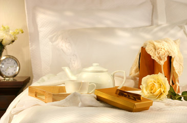 Morning tea in bed with chocolates and white sheets