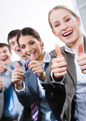 Vertical image of business people giving the thumbs-up sign