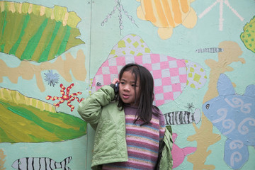 Wall Mural -  happy child outdoor jumping against a decorated wall