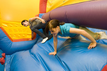 Two Girls Racing In Inflatable Toy