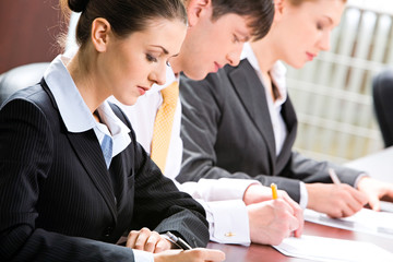 Canvas Print - Business people  writing something on the paper