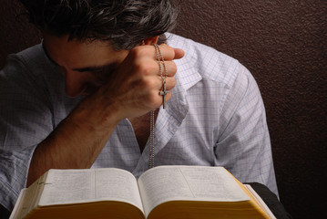 Wall Mural - holy bible open with a cross on a hand