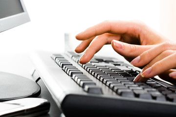 Poster - A business lady’s hands on the keys typing documents