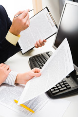 Sticker - Business people’s hands holding documents near computer