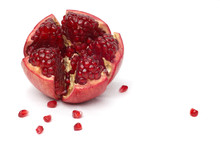 Broken Pomegranate And Seeds Over White Cloth.