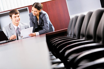 Sticker - A business man sitting and reading a document in the office 