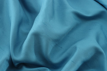 Crumpled natural blue silk background