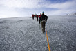 Group of people climbing glacier