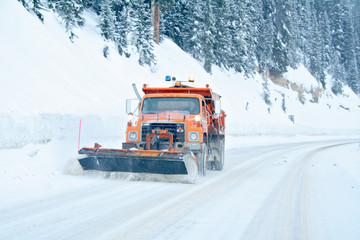 Snow plow removing snow from mountain highway