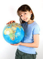 A young girl holding a globe against a white background