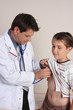 A doctor or paediatrician examines a child with stethoscope.