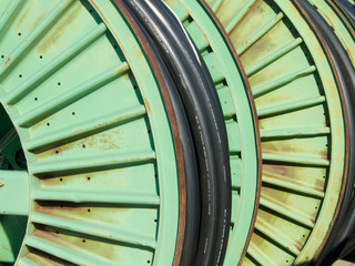 metal spools of wire in the yard of an electric utility company