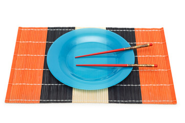 Blue plate with chopsticks isolated on white