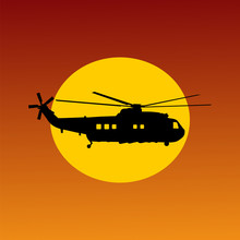 Helicopter Flying Passing Sun At Sunset