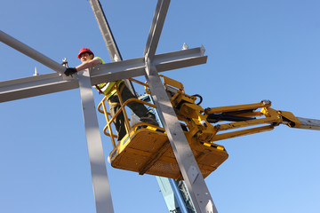 Steel worker on a cherry-picker