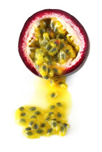 Passion Fruit, Cut, Spilling Onto White Surface.