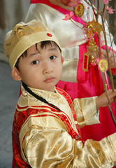 Wall Mural - young chinese kid wearing traditional costume and hat