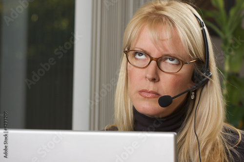 Fotografie, Obraz Bored Businesswoman on Telephone Headset