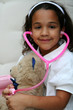 © Rob - Young girl plays doctor or nurse with stuffed animal