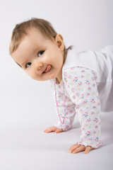 one year old cute caucasian baby girl making faces.