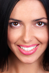 Wall Mural - Smiling  young woman face. Over white background.