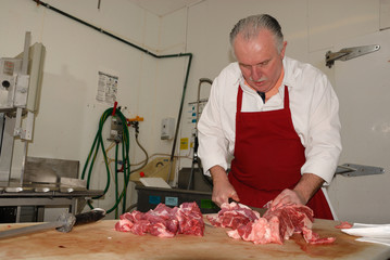 Butcher preparing boneless chuck steak