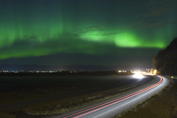 Wall Mural - Car taillight trails under northern lights in Alaska