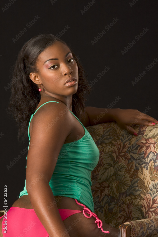Photo Stock Glamorous black girl in lingerie sitting in chair Adobe Stock